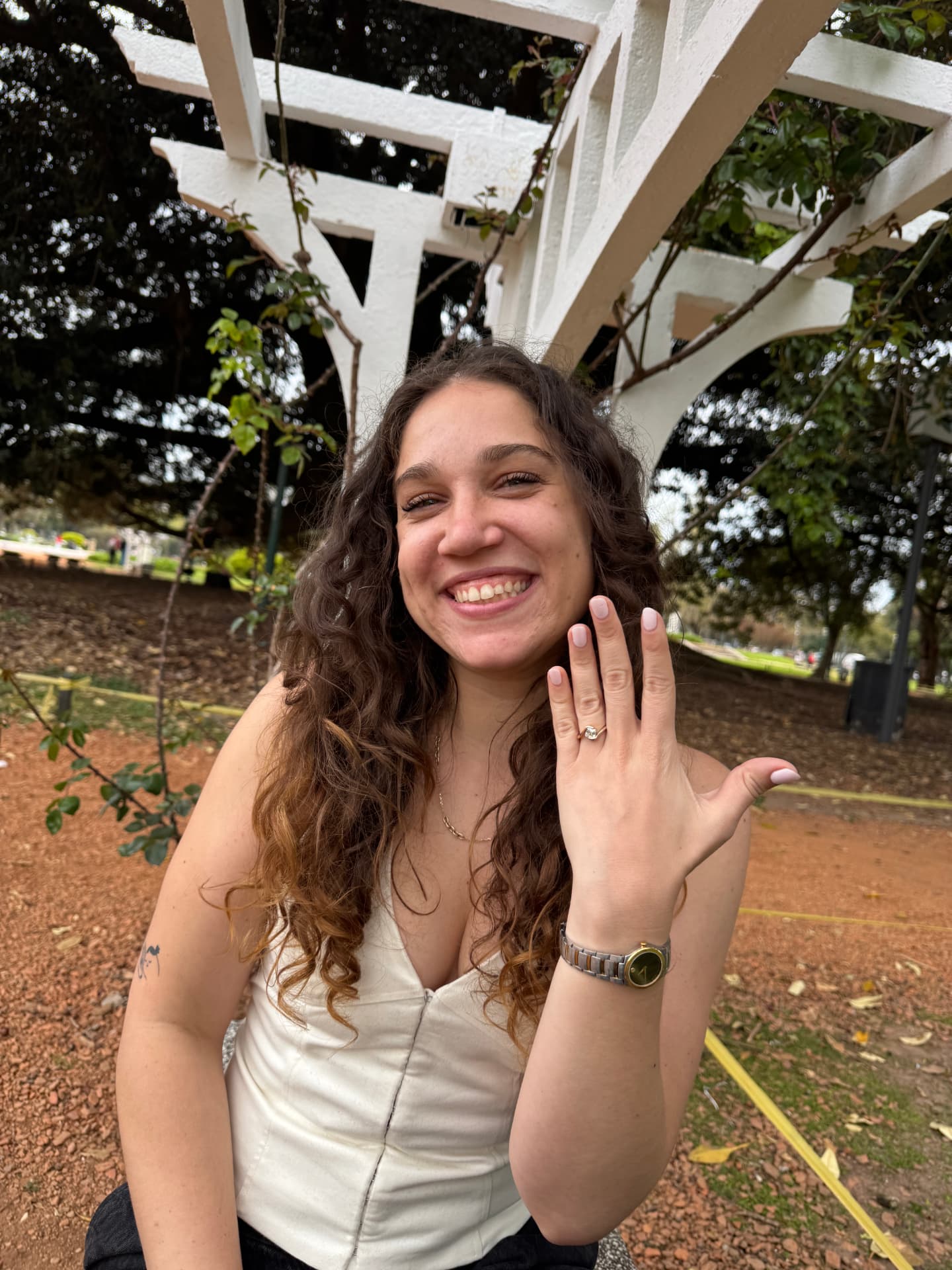 Mica showing her engagement ring in a Buenos Aires garden